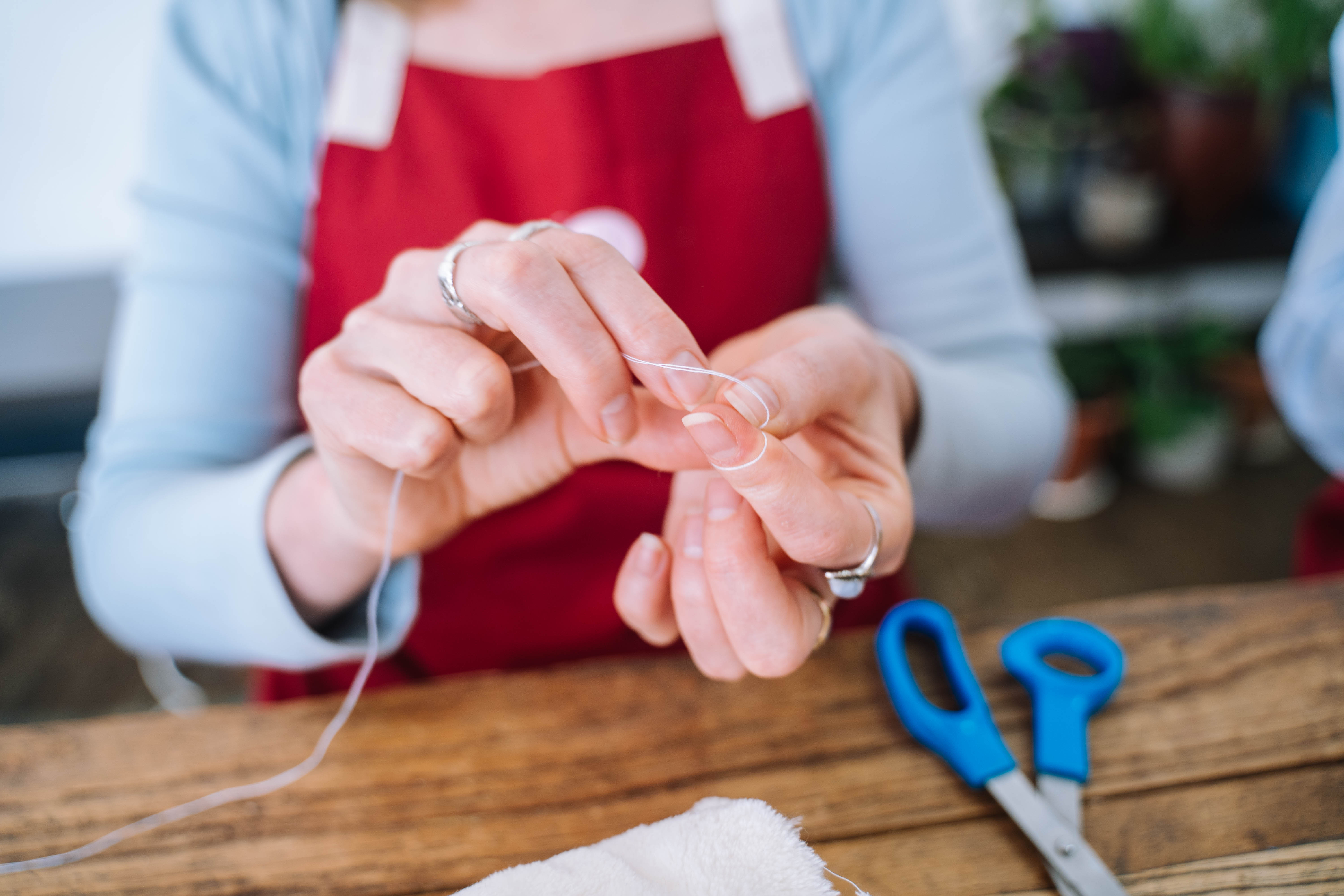 People sewing close up of hands